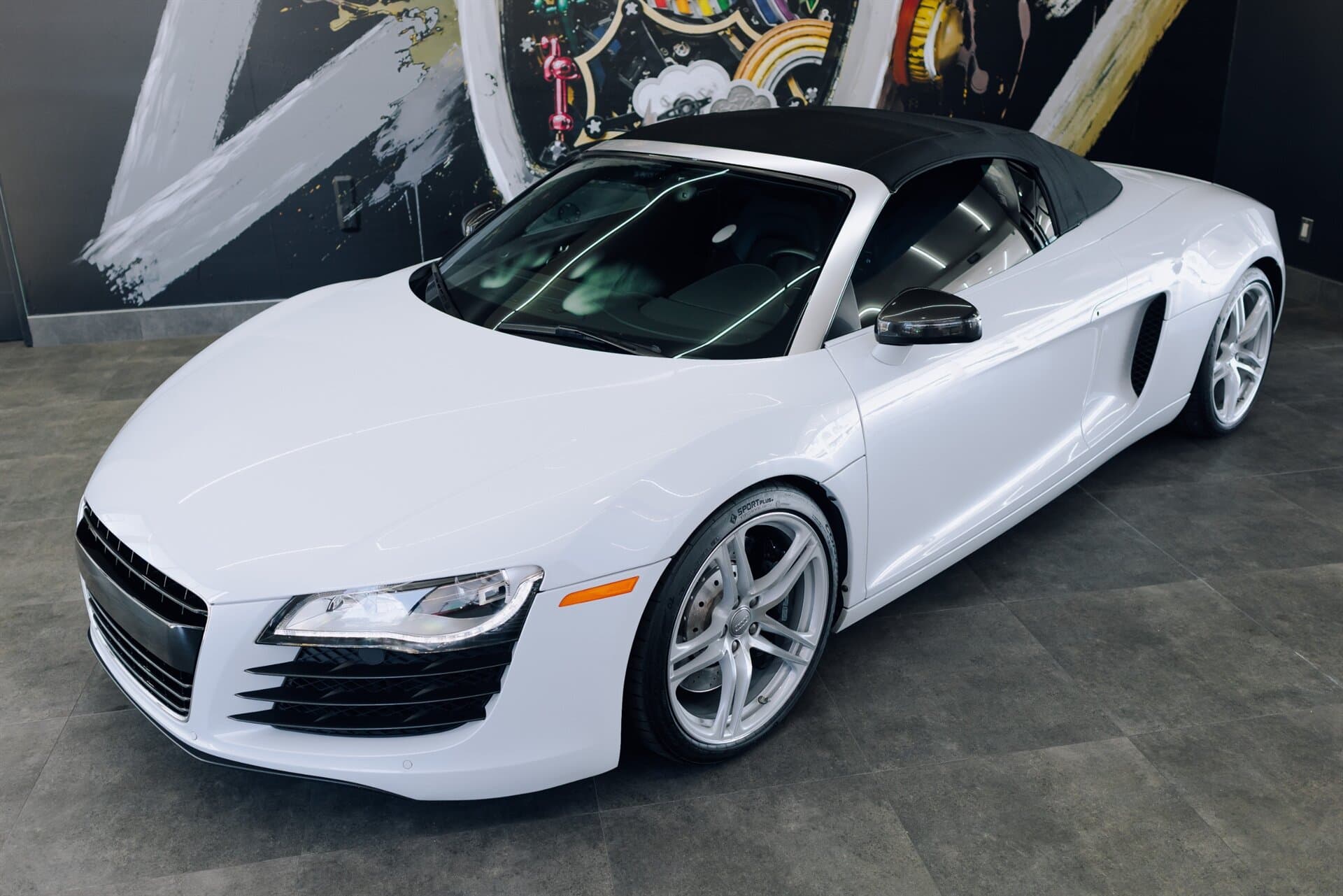 White Audi R8 Spyder in a dealership showroom